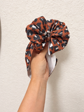 Brown cheetah bow
